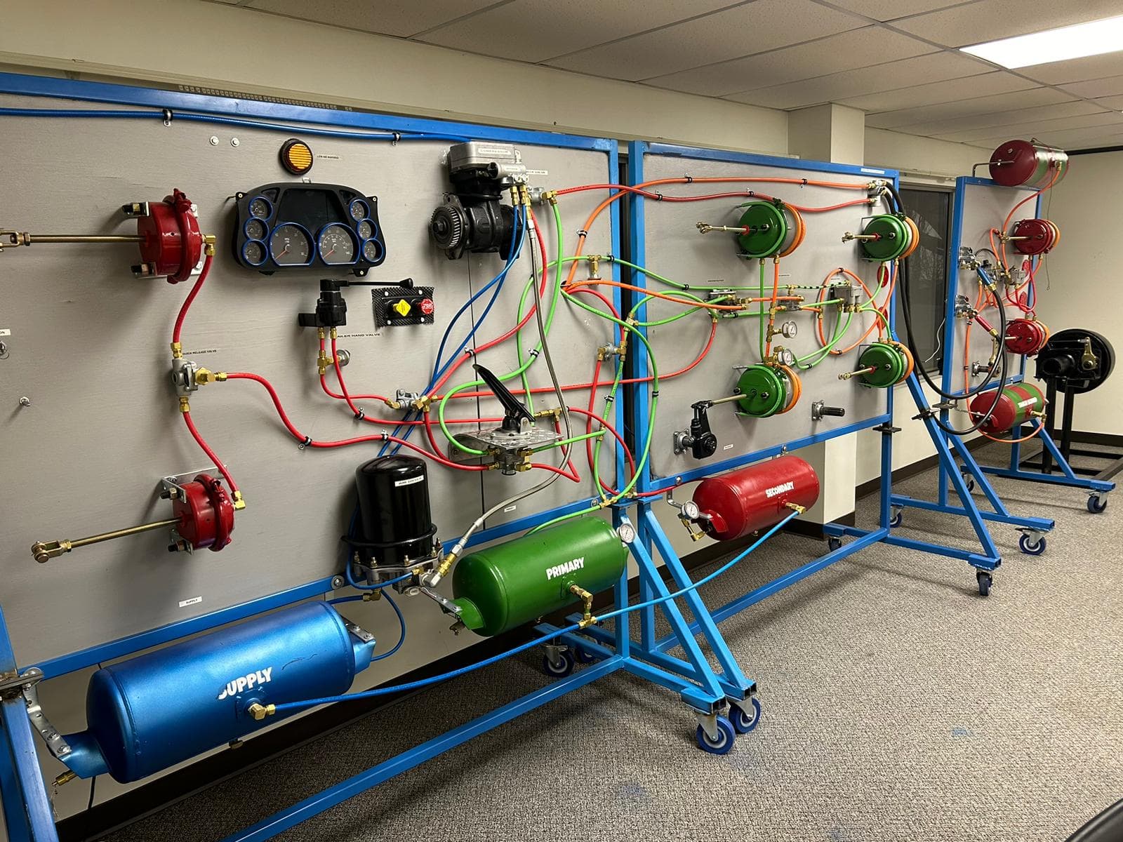 Classroom air brake training board with tanks, valves, and color-coded pneumatic lines