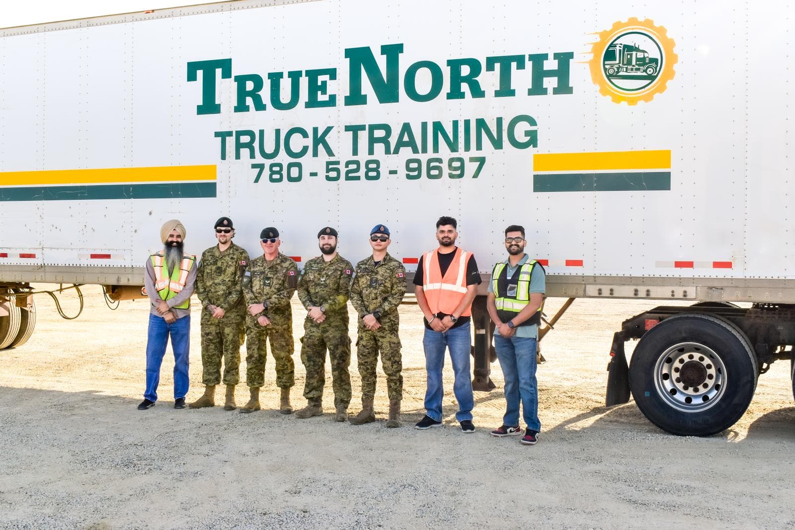 Canadian Forces members and True North instructors standing in front of a True North Truck Training trailer